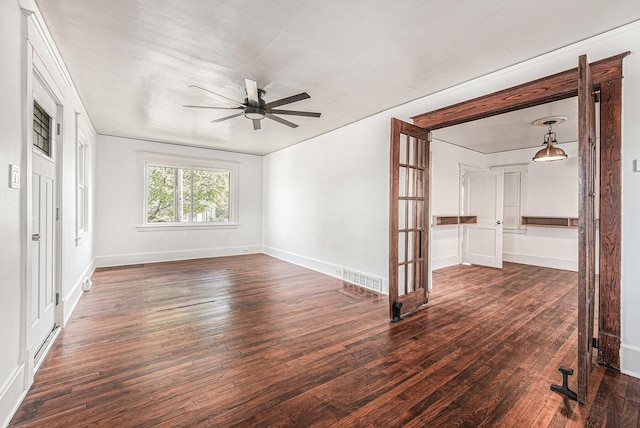 unfurnished room with visible vents, a ceiling fan, baseboards, and hardwood / wood-style flooring