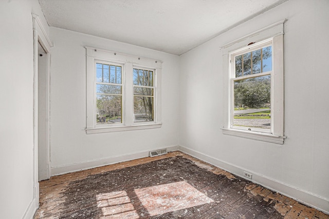 empty room with visible vents and baseboards