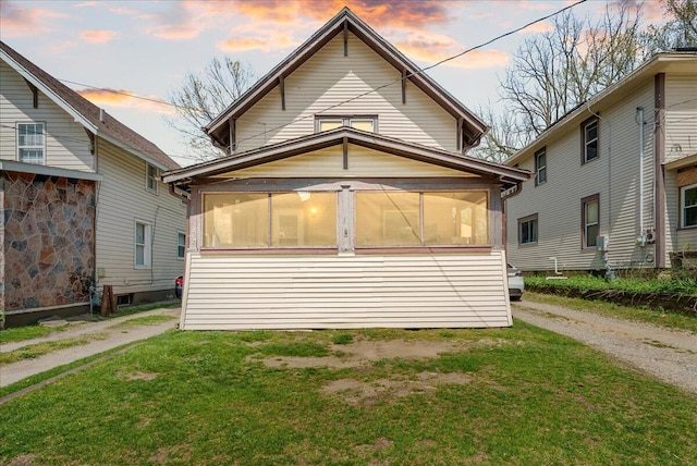 exterior space with a sunroom and a yard