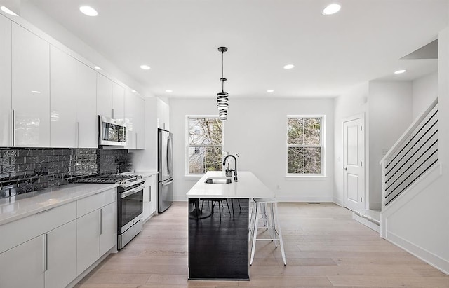 2878 Summers Pl, Troy, MI 48084 - kitchen featuring a sink, modern cabinets, stainless steel appliances, and white cabinetry