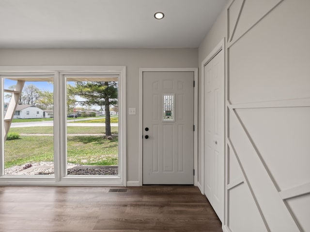 doorway featuring recessed lighting, baseboards, visible vents, and dark wood finished floors