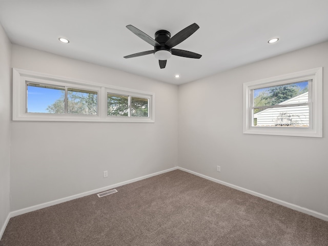 carpeted empty room featuring recessed lighting, visible vents, and a healthy amount of sunlight