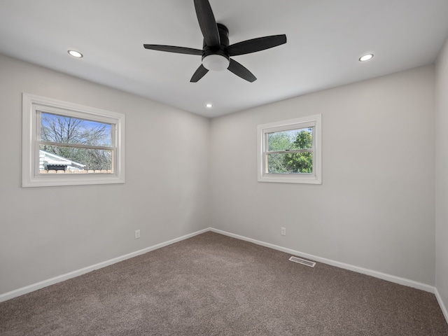 empty room with visible vents, recessed lighting, baseboards, and carpet floors