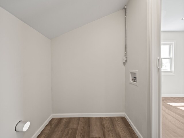 unfurnished room featuring baseboards and wood finished floors