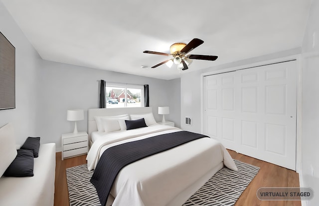 bedroom featuring wood finished floors, a closet, and ceiling fan