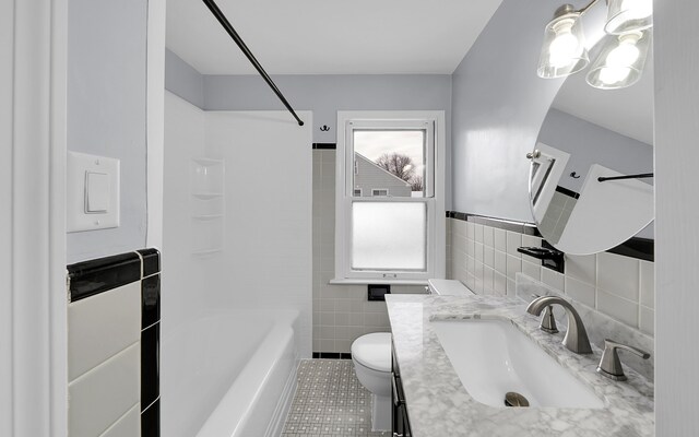 19852 Martin Rd, Saint Clair Shores, MI 48081 - full bathroom featuring tile walls, toilet, tile patterned flooring, vanity, and tub / shower combination