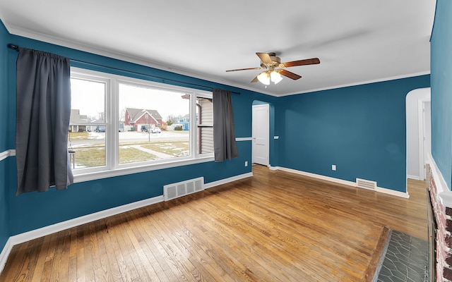 unfurnished room with a ceiling fan, baseboards, hardwood / wood-style floors, and ornamental molding