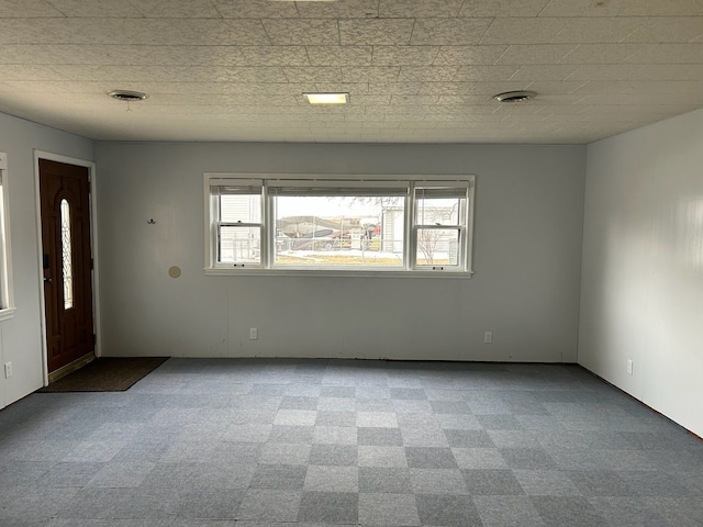 empty room featuring light carpet