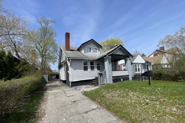 16837 Winthrop St, Detroit, MI 48235 - view of front of house with a front yard, driveway, and a chimney