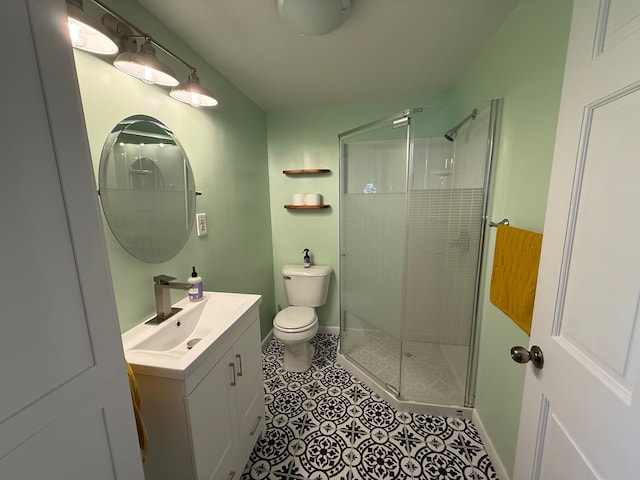 bathroom with vanity, tile patterned floors, a stall shower, and toilet