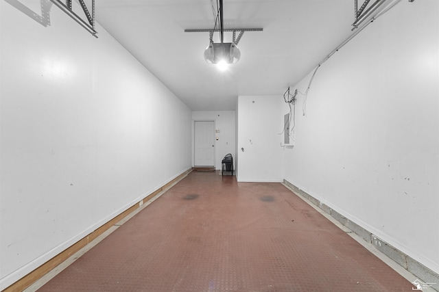 garage with baseboards and a garage door opener