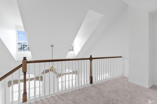 hallway featuring carpet floors and baseboards
