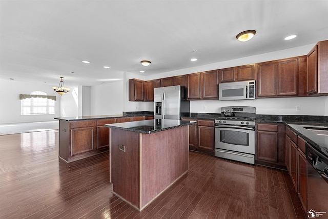 kitchen with recessed lighting, a kitchen island, stainless steel appliances, and dark wood-style floors