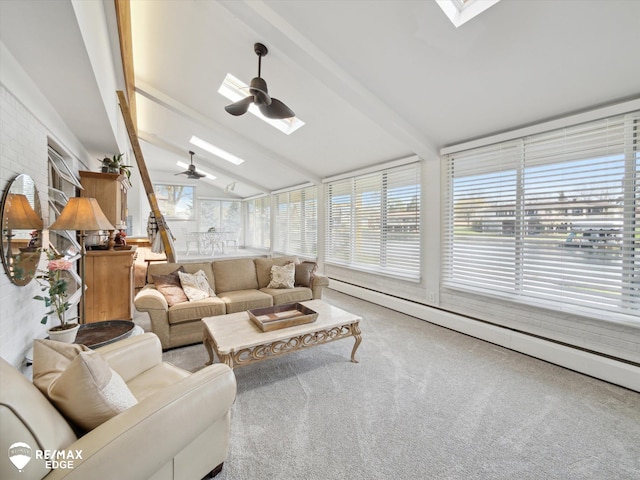 living room featuring ceiling fan, carpet flooring, and lofted ceiling with skylight