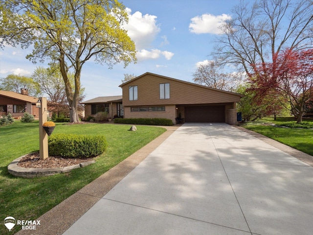 tri-level home featuring concrete driveway, brick siding, an attached garage, and a front lawn