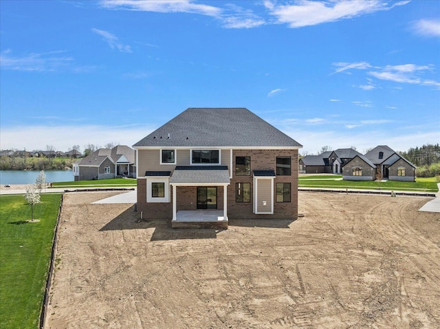 692 Westlake Ave, Oxford, MI 48371 - back of house featuring brick siding, a patio area, a water view, a yard, and a residential view