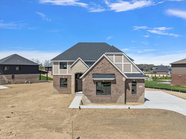 692 Westlake Ave, Oxford, MI 48371 - view of front of house with brick siding, driveway, and roof with shingles