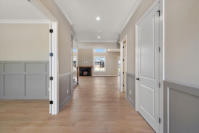 692 Westlake Ave, Oxford, MI 48371 - hallway featuring crown molding, a decorative wall, light wood-style flooring, a wainscoted wall, and recessed lighting
