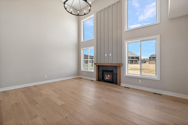 692 Westlake Ave, Oxford, MI 48371 - unfurnished living room with a chandelier, a high ceiling, and visible vents