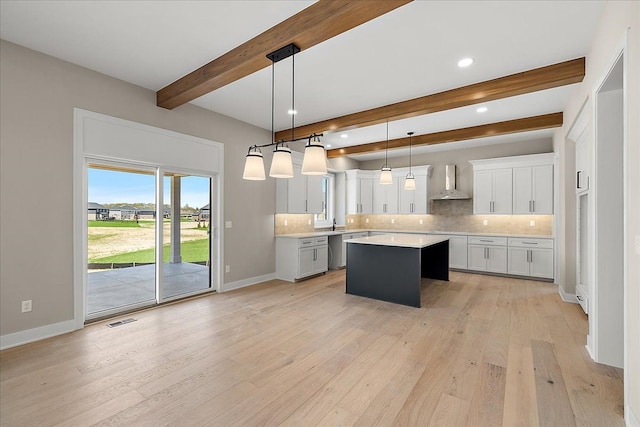 692 Westlake Ave, Oxford, MI 48371 - kitchen featuring visible vents, tasteful backsplash, light countertops, beamed ceiling, and wall chimney exhaust hood