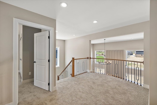 692 Westlake Ave, Oxford, MI 48371 - hallway with baseboards, recessed lighting, carpet, and an upstairs landing