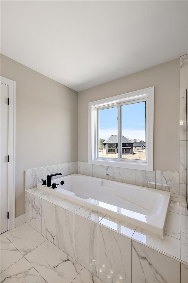 692 Westlake Ave, Oxford, MI 48371 - bathroom featuring a bath and marble finish floor