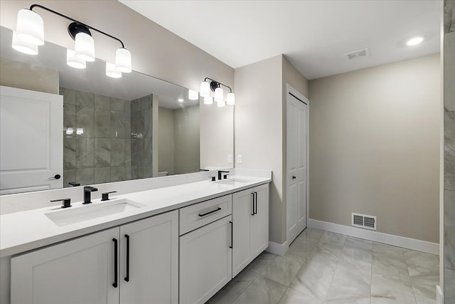 692 Westlake Ave, Oxford, MI 48371 - bathroom with visible vents, a sink, and marble finish floor
