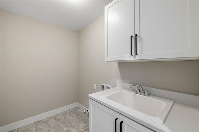 692 Westlake Ave, Oxford, MI 48371 - laundry room with cabinet space, washer hookup, a sink, marble finish floor, and baseboards