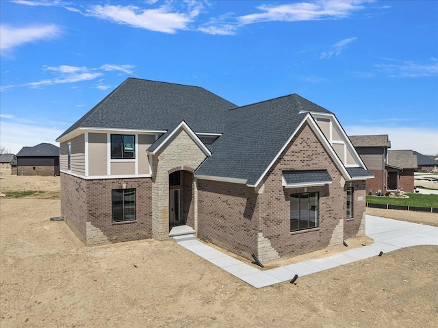 692 Westlake Ave, Oxford, MI 48371 - view of front of house featuring brick siding, driveway, and roof with shingles