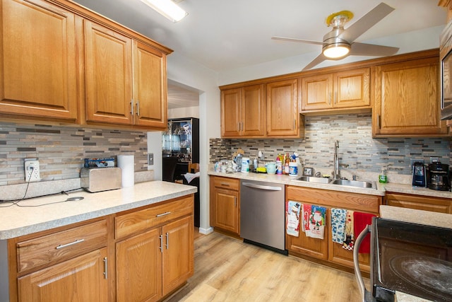 kitchen with stainless steel dishwasher, a sink, and tasteful backsplash
