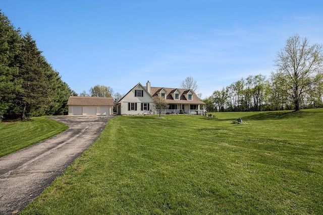 cape cod-style house featuring a detached garage, a chimney, an outbuilding, and a front lawn