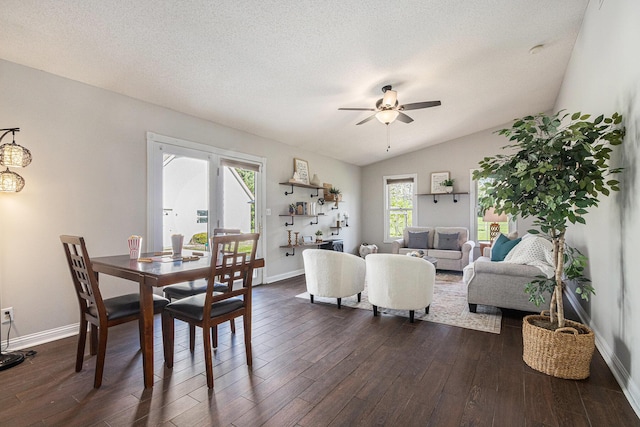 living room featuring dark wood-type flooring, baseboards, ceiling fan, and lofted ceiling
