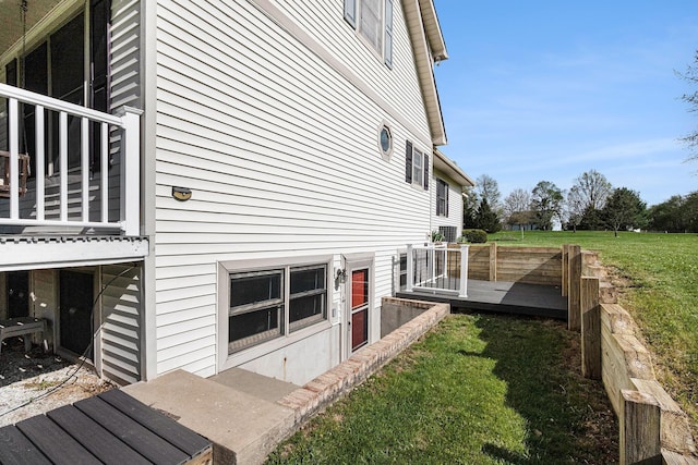 view of side of property featuring a yard and a deck