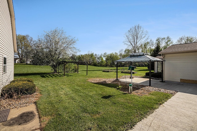view of yard featuring a gazebo and a patio area