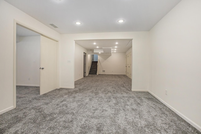 interior space featuring carpet floors, stairs, recessed lighting, baseboards, and visible vents