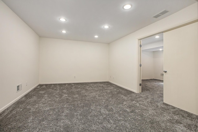 empty room featuring carpet floors, recessed lighting, and visible vents