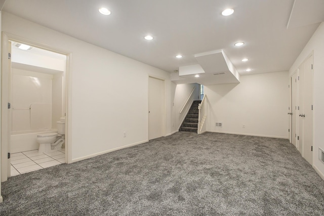 finished below grade area with carpet floors, recessed lighting, baseboards, visible vents, and stairway