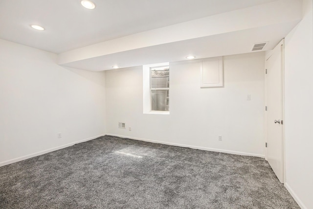 finished below grade area featuring visible vents, recessed lighting, baseboards, and carpet floors