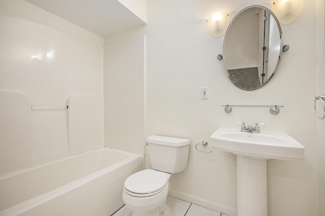 bathroom featuring toilet, tile patterned floors, and baseboards