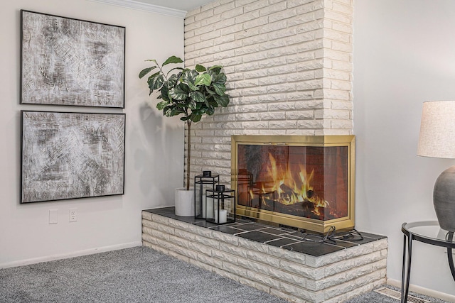 details with baseboards, ornamental molding, carpet, and a fireplace