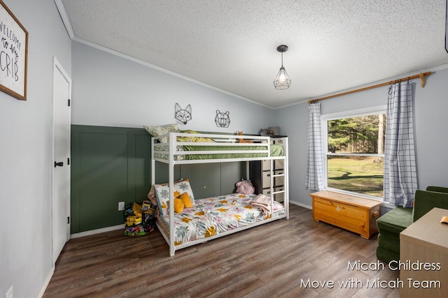 bedroom with crown molding, a textured ceiling, and wood finished floors