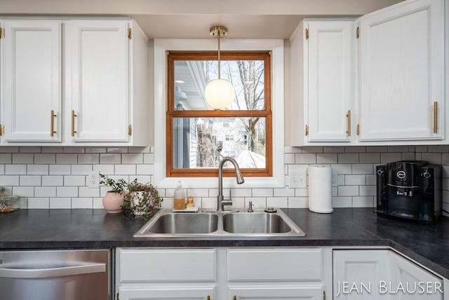 kitchen featuring a sink, dark countertops, white cabinets, and dishwasher
