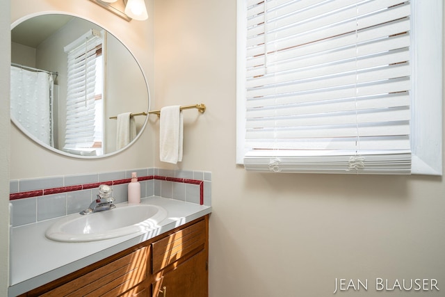 bathroom featuring vanity and decorative backsplash