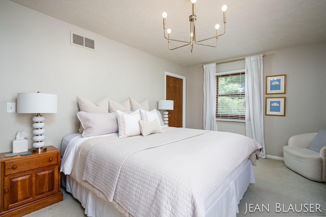 bedroom featuring an inviting chandelier, baseboards, light colored carpet, and visible vents