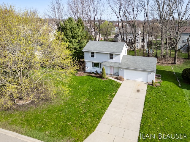 view of front of property featuring a residential view, a front lawn, concrete driveway, an attached garage, and a shingled roof