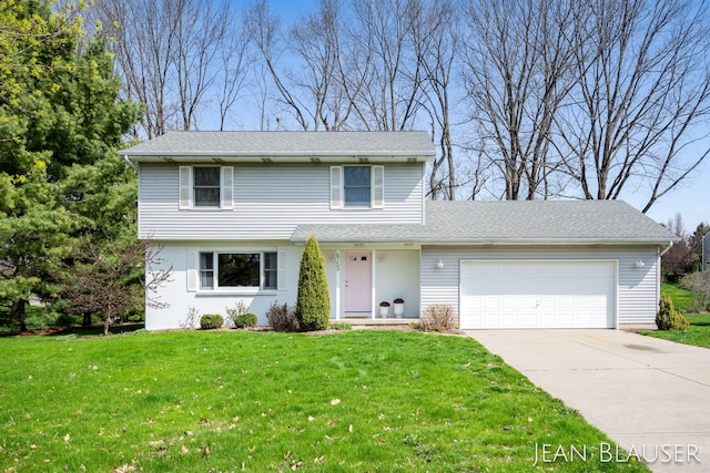 traditional-style home with an attached garage, driveway, and a front lawn
