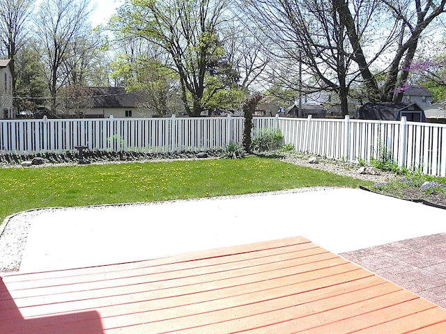 wooden deck with a patio, a fenced backyard, and a yard