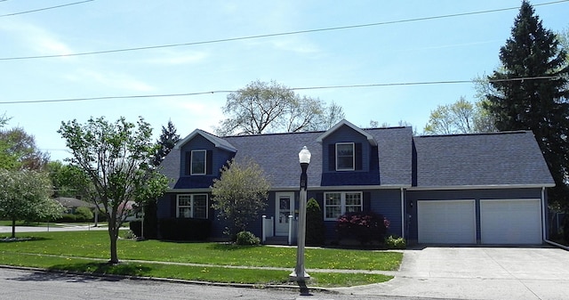 cape cod-style house with an attached garage, a shingled roof, a front yard, and concrete driveway