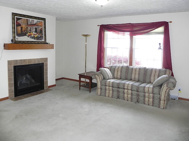 carpeted living room with baseboards, a fireplace, and a textured ceiling