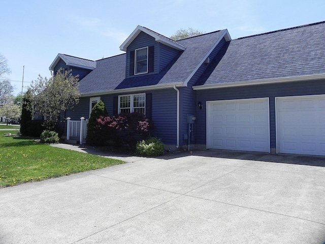 cape cod home featuring a garage, a front lawn, driveway, and roof with shingles